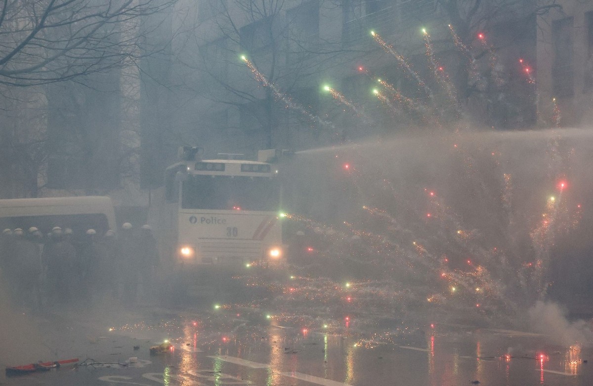 Police use a water cannon during a protest of European farmers over price pressures, taxes and green regulation, on the day of an EU Agriculture Ministers meeting in Brussels, Belgium February 26, 202 ...