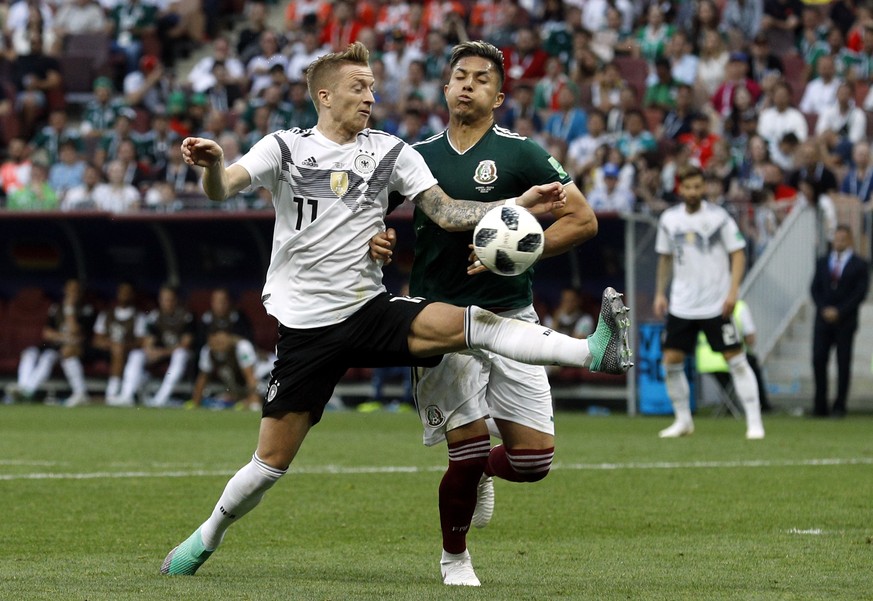 Germany's Marco Reus, left, fights for the ball with Mexico's Carlos Salcedo during the group F match between Germany and Mexico at the 2018 soccer World Cup in the Luzhniki Stadium in Moscow, Russia, ...