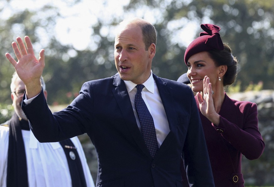 Britain&#039;s Prince William, and Kate, Princess of Wales, right, wave as they arrive at St Davids Cathedral, for a commemoration service on the first anniversary of Queen Elizabeth II&#039;s death,  ...