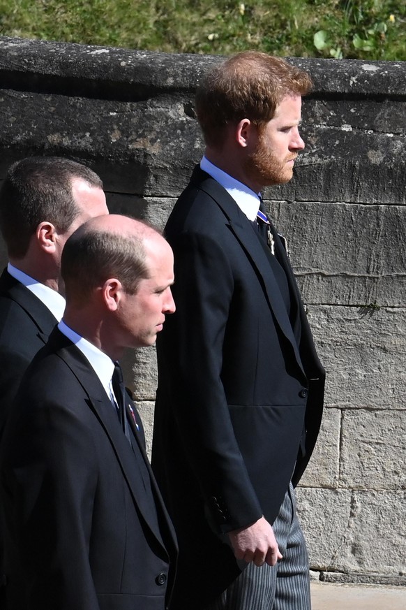 WINDSOR, ENGLAND - APRIL 17: Prince William, Duke of Cambridge, Peter Phillips and Prince Harry, Duke of Sussex follow Prince Philip, Duke of Edinburgh's coffin during the Ceremonial Procession during ...