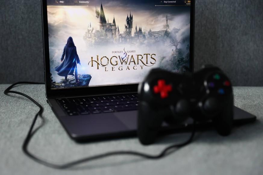 Hogwarts Legacy Photo Illustrations Hogwarts Legacy website displayed on a laptop screen and a gamepad are seen in this illustration photo taken in Krakow, Poland on February 8, 2023. Krakow Poland PU ...