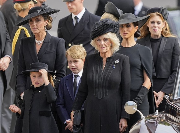 Kate, Princess of Wales, from left, Princess Charlotte, Prince George, Camilla, the Queen Consort, Meghan, Duchess of Sussex and Princess Beatrice follow the coffin of Queen Elizabeth II following her ...