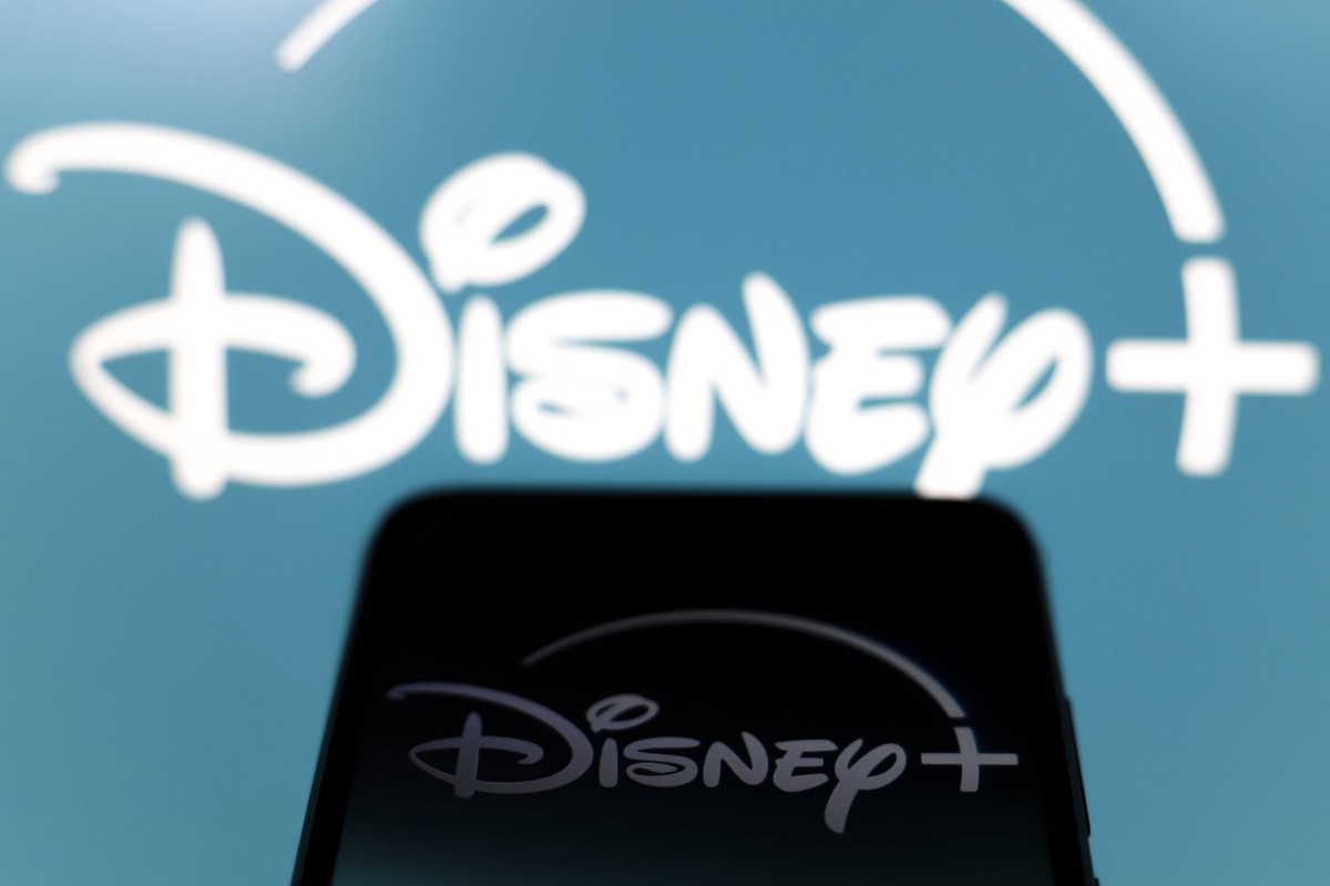 Streaming Video Apps The Disney Plus logo appears on the screen of a smartphone and in the background on the computer screen in Reno, United States, on December 15, 2024. Reno United States PUBLICATIO ...