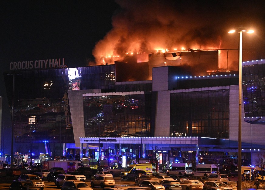 Russia Concert Shooting 8647694 22.03.2024 Smoke rises above the Crocus City Hall concert venue following a reported shooting incident, near Moscow, Russia. Several gunmen in combat fatigues burst int ...