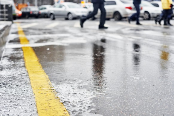 Closeup photo of winter snowy sleet road in the city