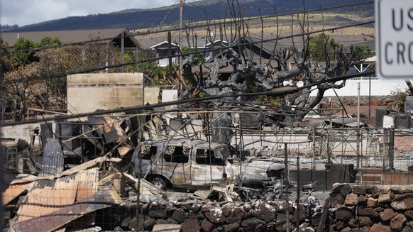 Destruction is seen in a neighborhood, Sunday, Aug. 13, 2023, in Lahaina, Hawaii, following a deadly wildfire that caused heavy damage days earlier. (AP Photo/Rick Bowmer)