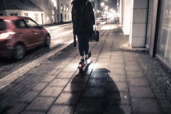 Person auf einem E-Scooter in Reykjavik E-Scooter *** Person on an E Scooter in Reykjavik E Scooter
