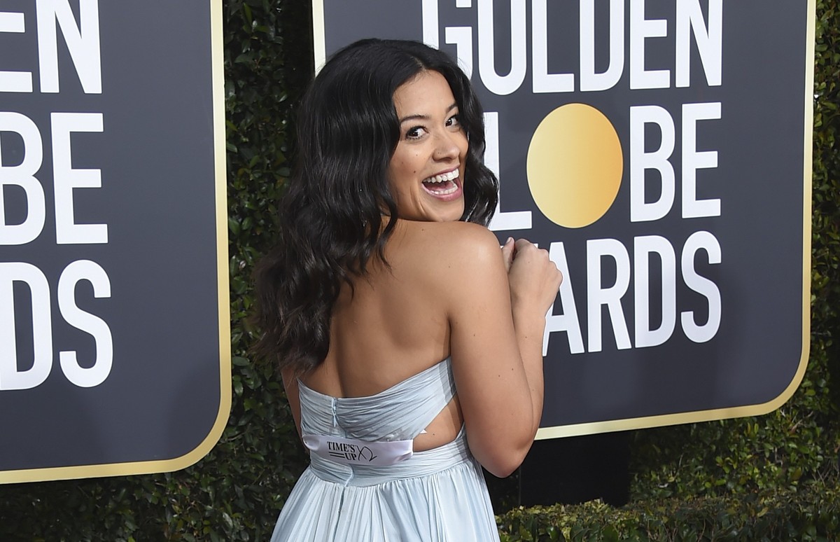 FILE - Gina Rodriguez poses on the red carpet with a ribbon that reads &quot;Time&#039;s Up,&quot; as she arrives at the 76th annual Golden Globe Awards at the Beverly Hilton Hotel on Jan. 6, 2019, in ...