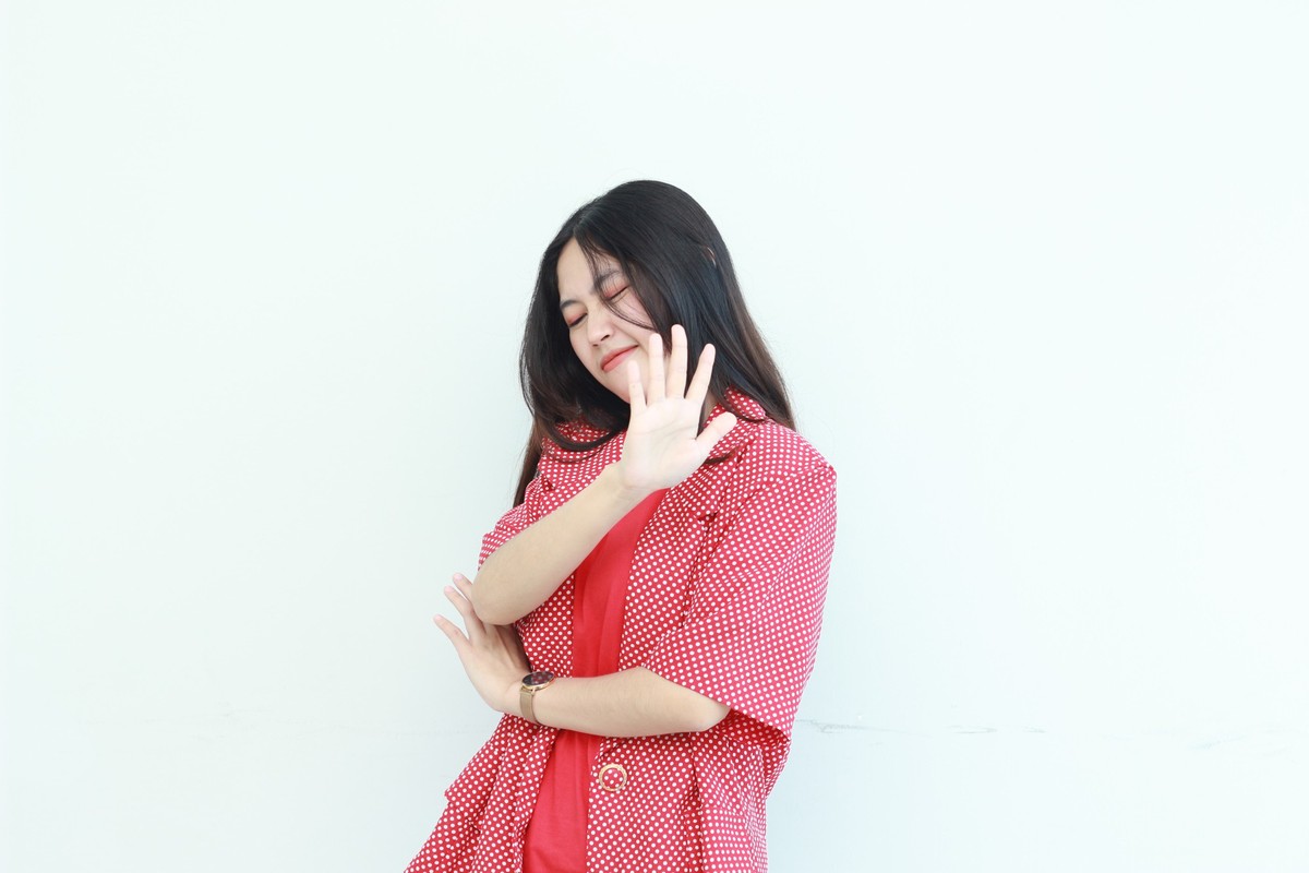 portrait of beautiful asian woman wearing red outfit with rejection or disapproval gesture isolated on white background. Model Released Property Released xkwx {gesture expression serious palm showing  ...
