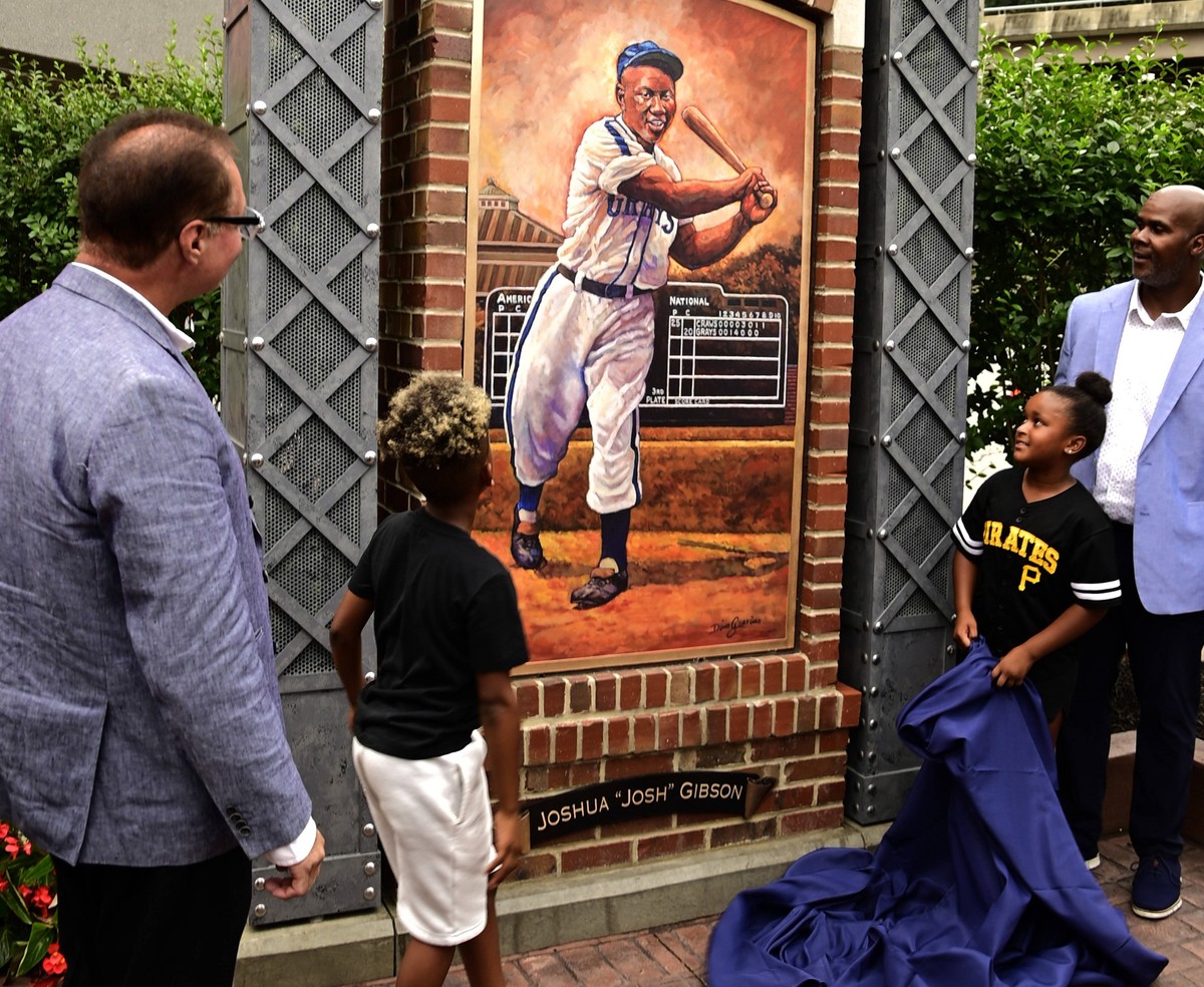 Artist Dino Guarino left and Sean Gibson great-grandson of the Hall of Famer Josh Gibson unveils one the the several colorize bronze statues at the Josh Gibson Heritage Park on Thursday August 4, 2022 ...