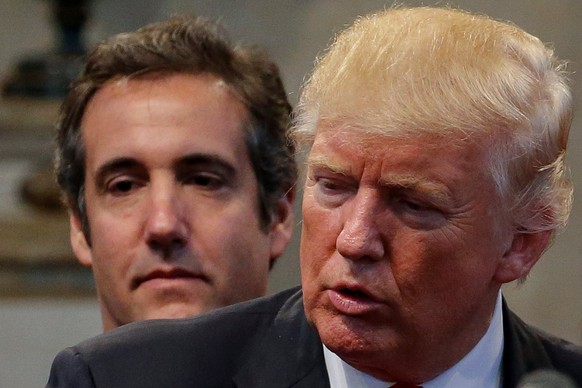 Republican presidential nominee Donald Trump&#039;s personal attorney Michael Cohen stands behind Trump as a group of supporters lay hands on Trump in prayer during a campaign stop at the New Spirit R ...