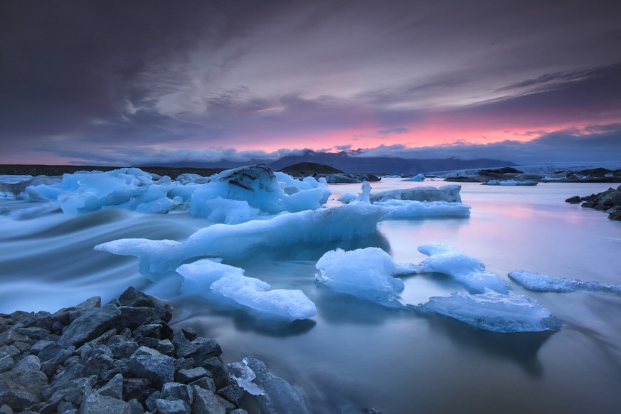 Icebergs floating in Jokulsarlon glacier lake at sunset.South Iceland.