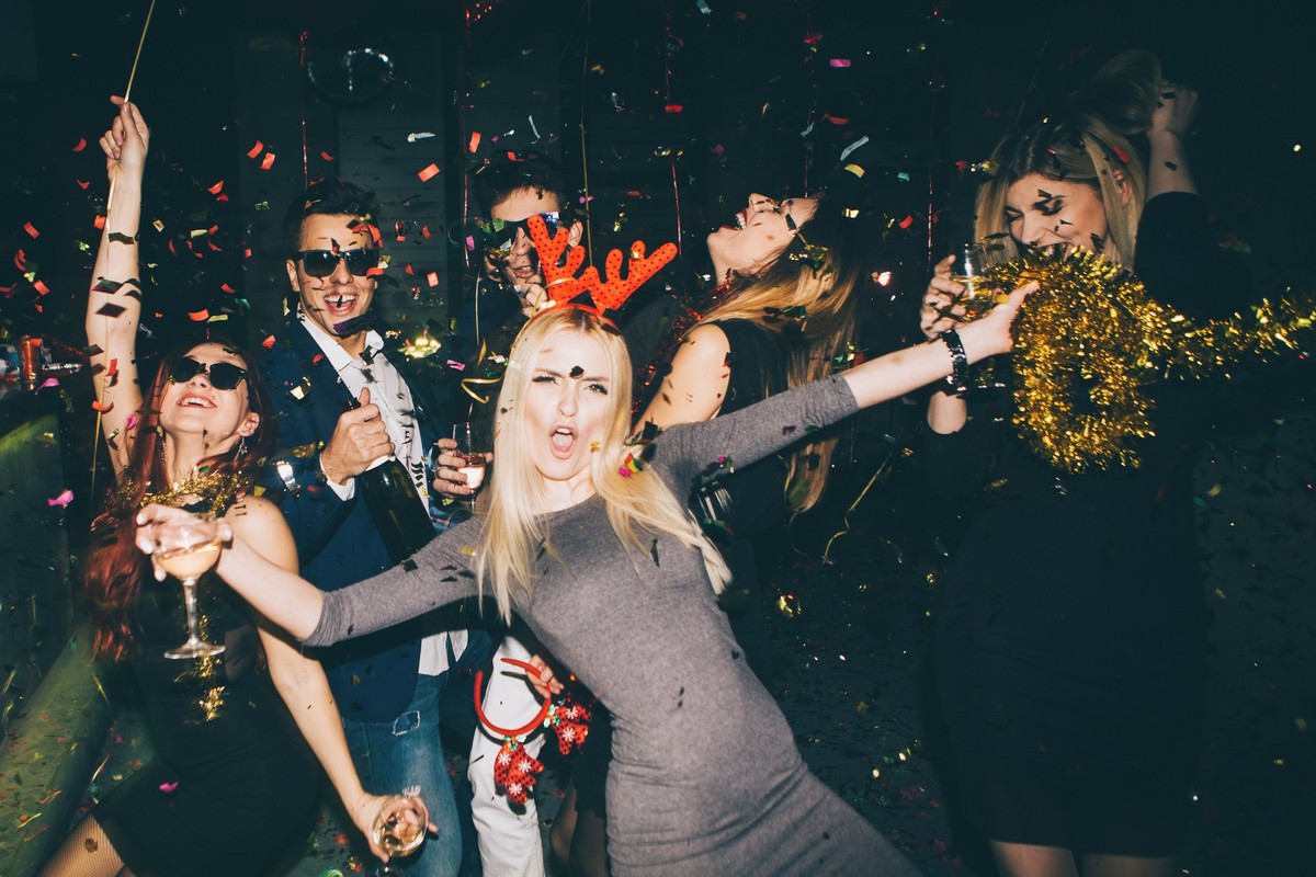Group of friends having fun for new year&#039;s eve in a club. Drinking and dancing together