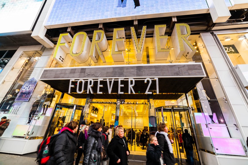 New York City, NY, USA - December 4, 2014: View of Forever 21 storefront in Times Square, NYC. Pedestrians and tourists on street outside front entrance.