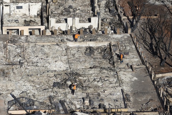 11.08.2023, USA, Lahaina: Rettungskräfte durchsuchen Häuser, die durch Waldbrände zerstört wurden. Die Zahl der Toten nach den verheerenden Busch- und Waldbränden ist weiter gestiegen, während die Lös ...