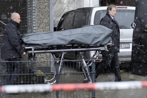 Corpses are carried out of a Jehovah&#039;s Witness building in Hamburg, Germany Friday, March 10, 2023. Shots were fired inside the building used by Jehovah&#039;s Witnesses in the northern German ci ...