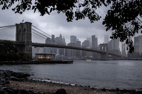 The Brooklyn Bridge passes over the carousel at Brooklyn Bridge Park and spans the East River with the New York skyline in the background, Saturday, Oct. 1, 2022. (AP Photo/Julia Nikhinson)