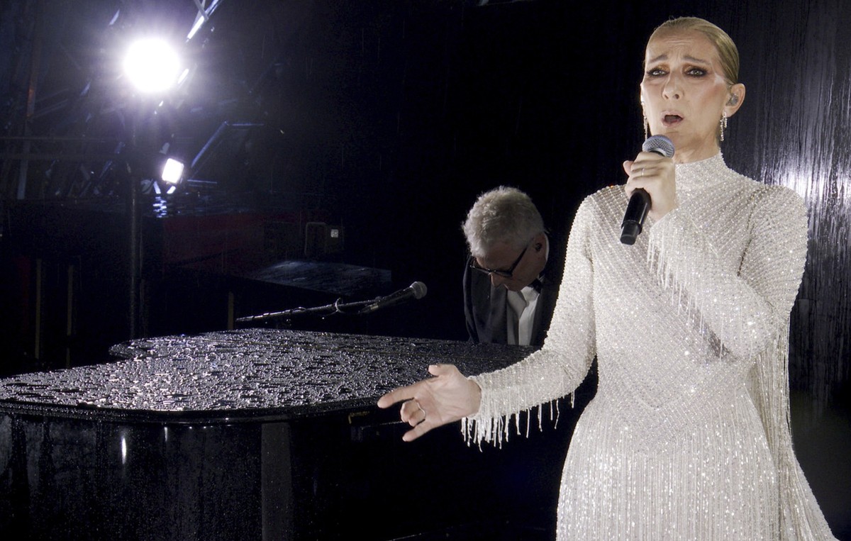 This photo released by the Olympic Broadcasting Services shows Canadian Singer Celine Dion performing on the Eiffel Tower during the opening ceremony for the 2024 Summer Olympics in Paris, France, Fri ...