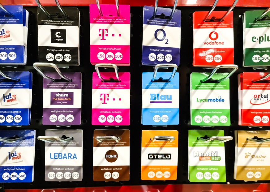 Kiel, Germany - 12 December 2023: Prepaid cards for Deutsche Telekom and Congstar telephone providers on sale in a supermarket