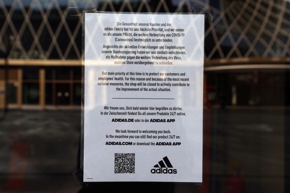 A note hangs on a door of the Adidas shop as it is closed, following an outbreak of the coronavirus disease (COVID-19), in Frankfurt, Germany March 27, 2020. REUTERS/Kai Pfaffenbach