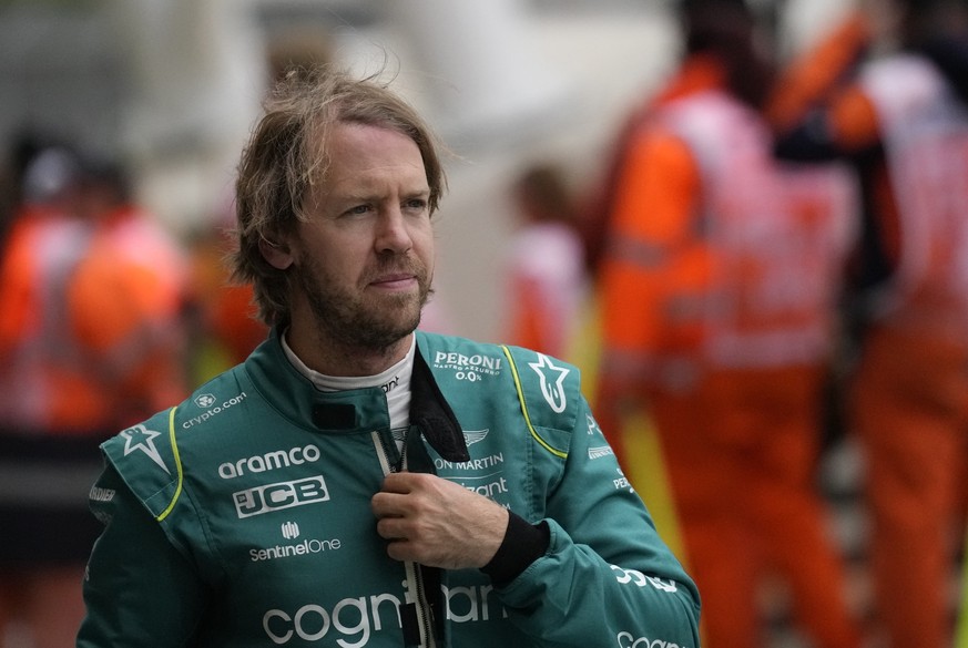 FILE - Aston Martin driver Sebastian Vettel of Germany walks after the third free practice at the Silverstone circuit, in Silverstone, England, Saturday, July 2, 2022. Four-time Formula One champion S ...