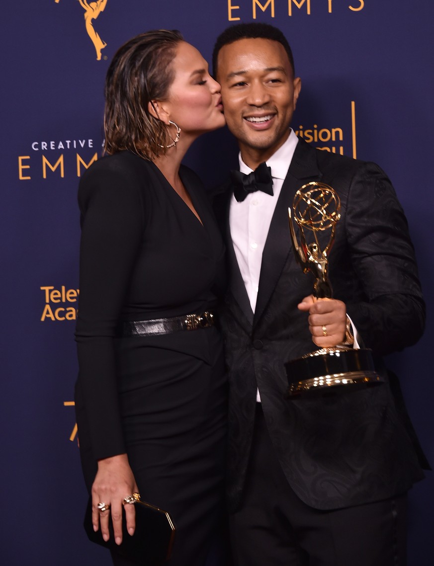 LOS ANGELES, CA - SEPTEMBER 09: Chrissy Teigen and John Legend pose in the press room during the 2018 Creative Arts Emmys at Microsoft Theater on September 9, 2018 in Los Angeles, California. (Photo b ...