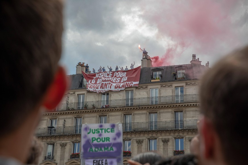 FRANCE - PARIS - PROTEST AGAINST POLICE VIOLENCE - 2020 Demonstrators watch as an extreme right-wing group rolls up a banner in an attempt to destabilize the demonstration. Paris, France. 13 June 2020 ...