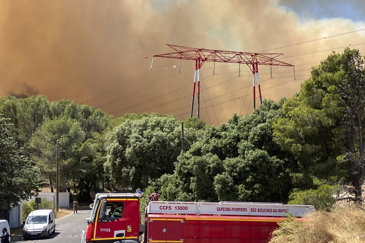 This photo provided by the fire brigade SDIS13, smoke rises during a wildfire near Marseille, southern France, Tuesday, July 8, 2025. (SDIS13 via AP)