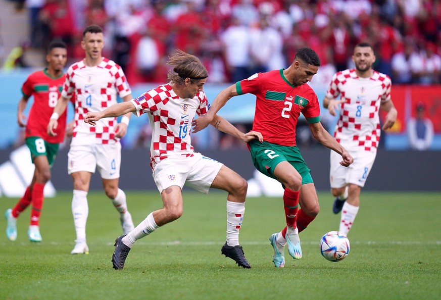 Morocco v Croatia - FIFA World Cup, WM, Weltmeisterschaft, Fussball 2022 - Group F - Al Bayt Stadium Morocco s Achraf Hakimi right and Croatias Borna Sosa battle for the ball during the FIFA World Cup ...