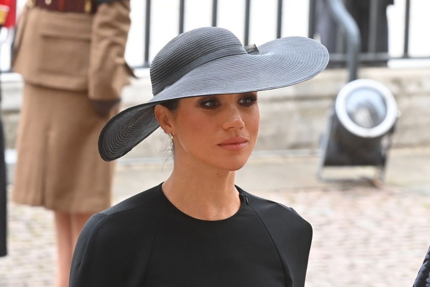 LONDON, ENGLAND - SEPTEMBER 19: Meghan, Duchess of Sussex walks behind The Queen&#039;s funeral cortege borne on the State Gun Carriage of the Royal Navy as it proceeds towards Westminster Abbey on Se ...