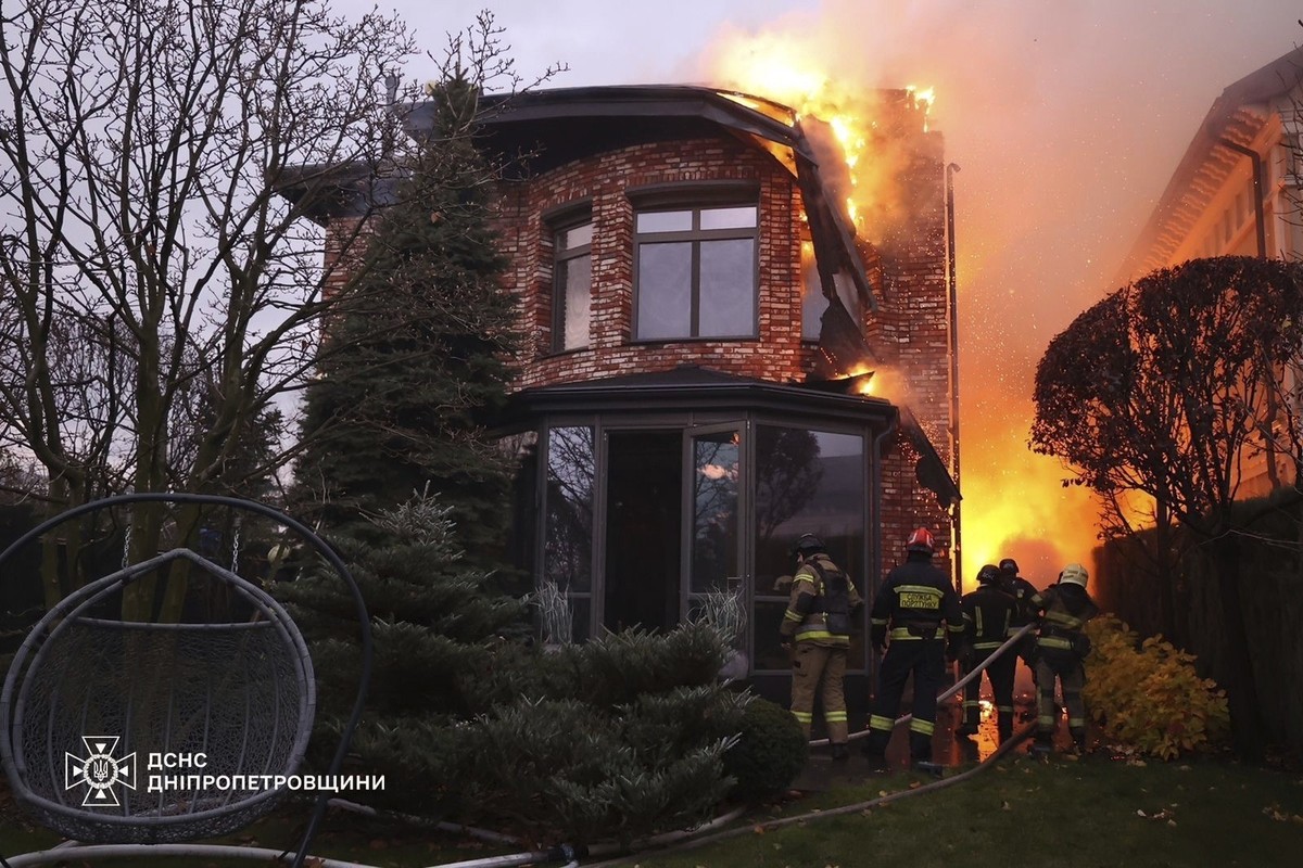 In this photo provided by the Ukrainian Emergency Services on Nov. 21, 2024, rescue workers put out a fire of a burning house damaged by a Russian strike on Dnipro, Ukraine. (Ukrainian Emergency Servi ...