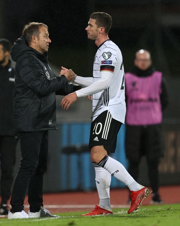 REYKJAVIK, ICELAND - SEPTEMBER 08: Head coach Hans-Dieter Flick of Germany shakes hands with Robin Gosens after the 2022 FIFA World Cup Qualifier match between Iceland and Germany at Laugardalsvollur  ...