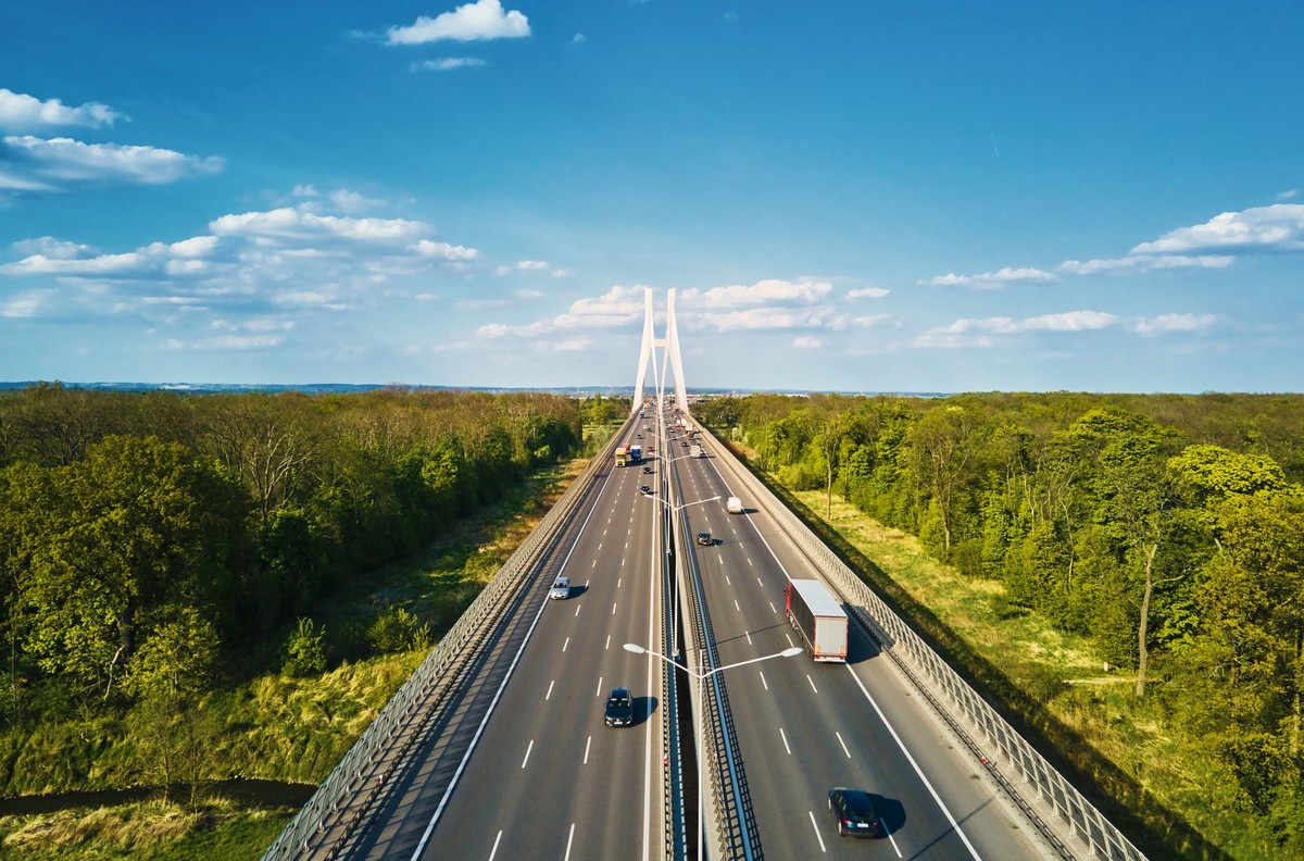 Large modern bridge over river in europe city with car traffic, aerial view. Redzinski bridge over Oder in Wroclaw, Poland