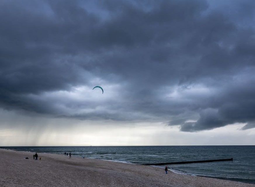 25.03.2023, Mecklenburg-Vorpommern, Graal-Müritz: Dunkle Regenwolken ziehen über der Ostsee. Mit wechselhaftem Wetter, starken Regenschauern aber auch sonnigen Abschnitten, zeigt sich das Frühlingswet ...