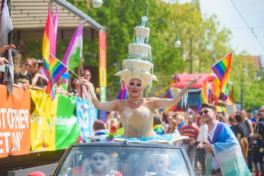 May 20, 2023, Dessau, Saxony-Anhalt, Germany: An attendee in a fancy costume waves pride flags as she takes part in Christopher Street Day parade. Christopher Street Day CSD is an annual LGBTQ celebra ...