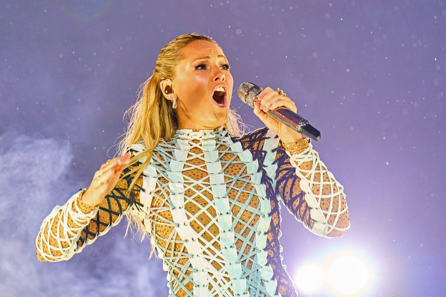 Singer and artist Helene Fischer, GER in front of a rainbow at her concert at the fairground on Aug 20, 2022 in Munich , Germany.