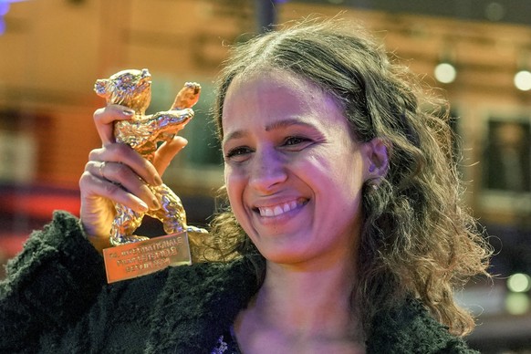 Director Mati Diop displays the Golden Bear she received for her documentary &quot;Dahomey&quot; at the International Film Festival, Berlinale, in Berlin, Saturday, Feb. 24, 2024. (AP Photo/Markus Sch ...