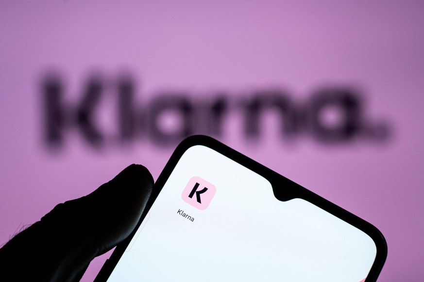 Fintech And Neobanks Stock Photos A person is holding a mobile phone with the Klarna application in front of a screen displaying the Klarna logo. Athens Greece PUBLICATIONxNOTxINxFRA Copyright: xNikos ...