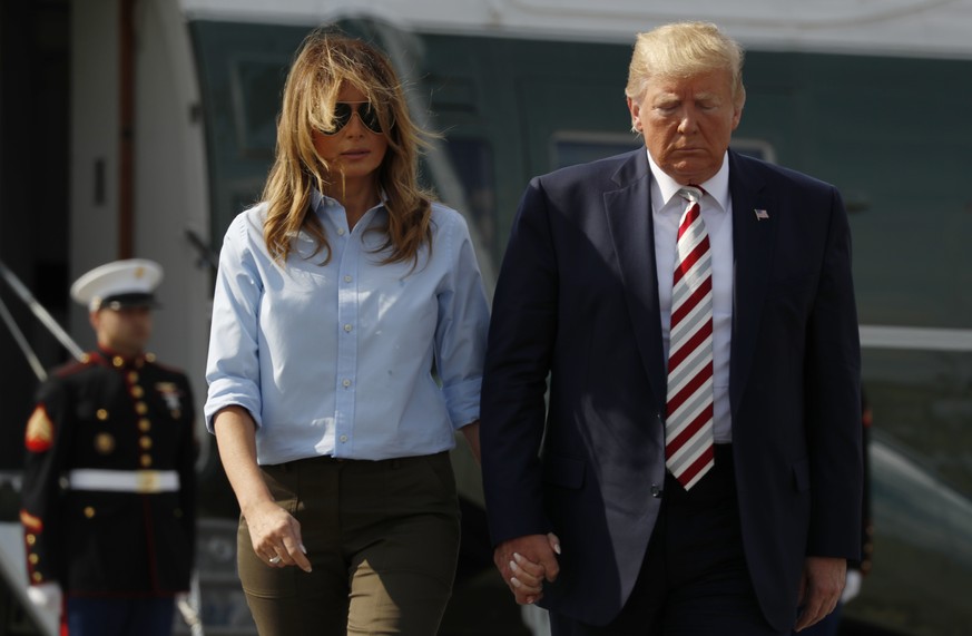 President Donald Trump, with first lady Melania Trump, walks towards the media before speaking in Morristown, N.J., Sunday, Aug. 4, 2019. (AP Photo/Jacquelyn Martin)