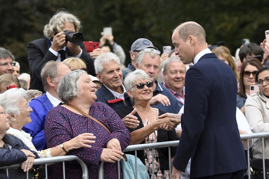 Britain's William, Prince of Wales greets well-wishers as he and Kate, Princess of Wales view floral tributes left by members of the public, in memory of late Queen Elizabeth II, at the Sandringham Es ...