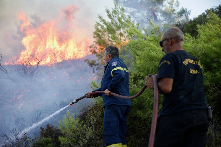 July 23, 2023, Rhodes island, Greece: A firefighter tries to put out a wildfire in Asklipio village, on Rhodes island. Local people and tourists have been evacuated from area after wild fires broke ou ...