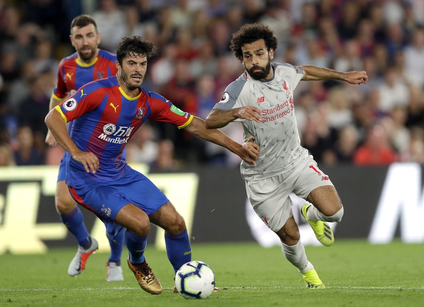 Crystal Palace's James Tomkins, left, duels for the ball with Liverpool's Mohamed Salah during the English Premier League soccer match between Crystal Palace and Liverpool at Selhurst Park stadium in  ...