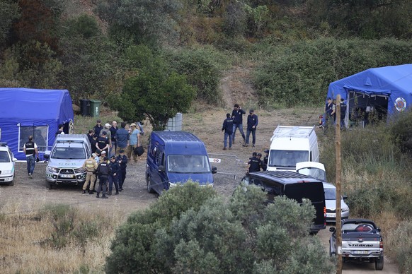 Police officers talk by an operation tent near Barragem do Arade, Portugal, Tuesday May 23, 2023. Portuguese police said they will resume searching for Madeleine McCann, the British toddler who disapp ...