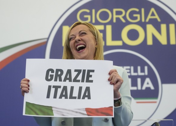 Far-Right party Brothers of Italy&#039;s leader Giorgia Meloni shows a placard reading in Italian &quot;Thank you Italy&quot; at her party&#039;s electoral headquarters in Rome, early Monday, Sept. 26 ...