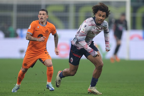 Milan, Italy, 20th December 2023. Joshua Zirkzee of Bologna FC is pursued by Stefano Sensi of FC Internazionale as he breaks forward during the Coppa Italia match at Giuseppe Meazza, Milan. Picture cr ...