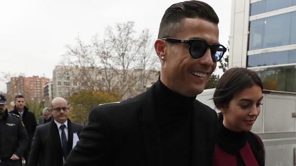 Cristiano Ronaldo arrives at the court in Madrid on Tuesday, Jan. 22, 2019. Cristiano Ronaldo is expected to plead guilty to tax fraud. The Juventus forward arrived in a black van, walked up some stai ...
