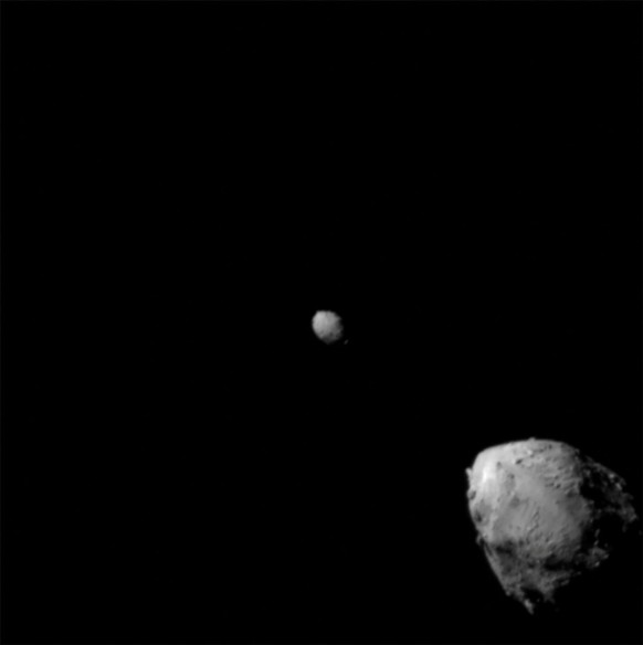 FILE PHOTO: The last image to contain a complete view of asteroid Didymos (top left) and its moonlet, Dimorphos, about 2.5 minutes before the impact of NASA’s DART spacecraft, taken by the on board DR ...