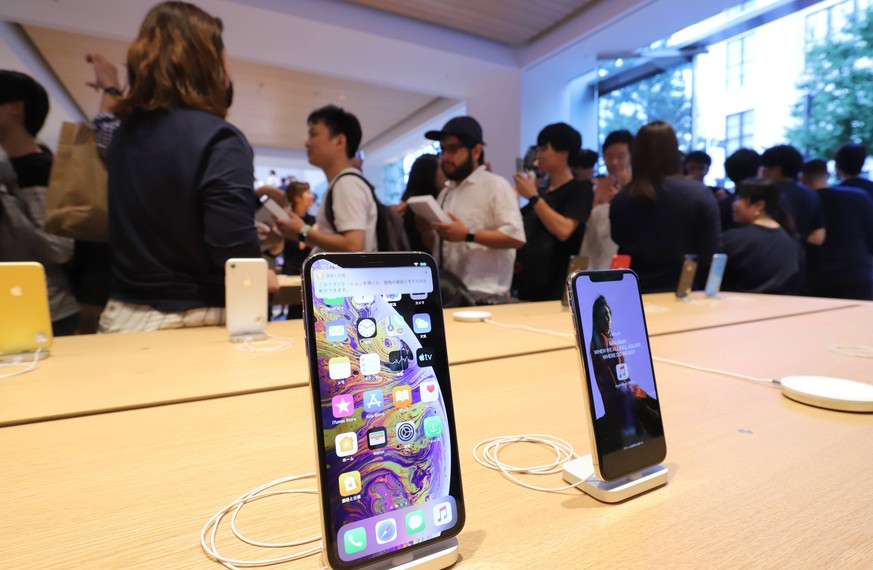 September 7, 2019, Tokyo, Japan - Apple store employees greet customers as Apple Japan opens the new shop Apple Marunouchi in Tokyo on Saturday, September 7, 2019. Some 1,500 Apple fans queue up for J ...