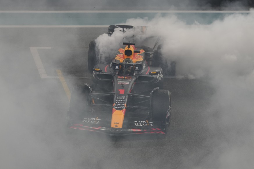 Red Bull driver Max Verstappen of the Netherlands spins in his car as he celebrates winning the Abu Dhabi Formula One Grand Prix race at the Yas Marina Circuit, Abu Dhabi, UAE, Sunday, Nov. 26, 2023.  ...