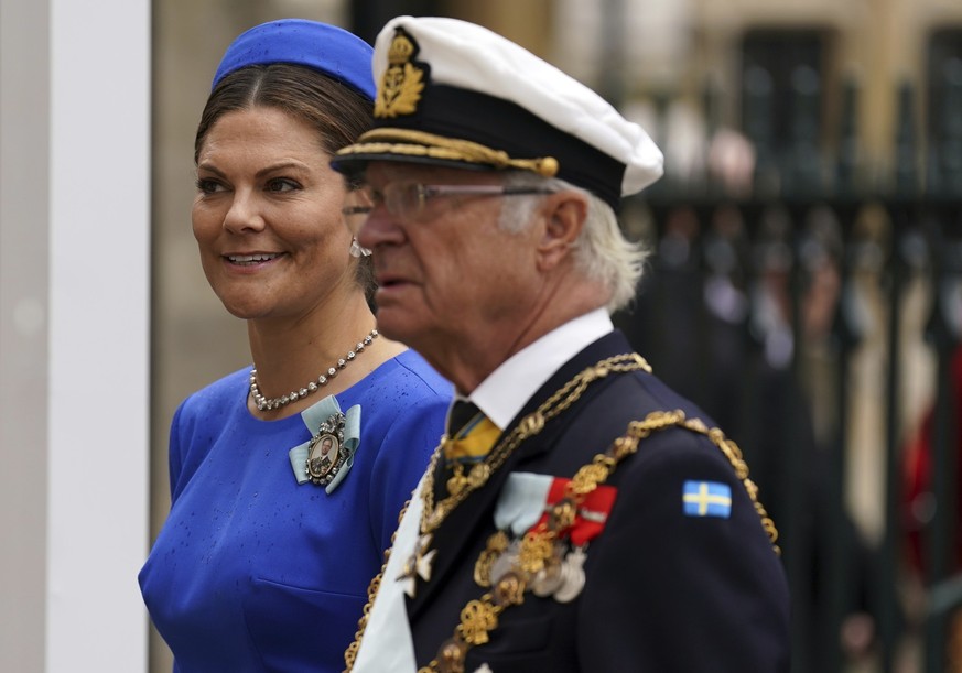 King of Sweden Carl XVI Gustaf, right with Crown Prince Victoria arrive at Westminster Abbey ahead of the coronation of King Charles III and Camilla, the Queen Consort, in London, Saturday, May 6, 202 ...